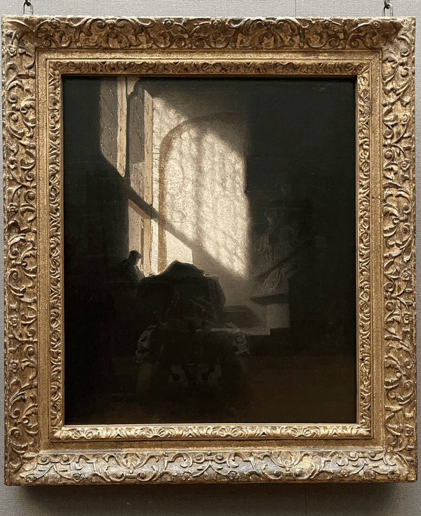 A man seated reading at a Table in a Lofty Room - follower of Rembrandt 